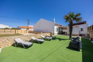 a group of lounge chairs on a lawn at SagresSeaHouse in Sagres