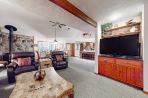 a living room with a large flat screen tv at Crystal Mountain Retreat in Thompsonville +31 photos