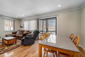 a living room with a table and a couch at Hideaway Valley Condo 36 in Harbor Springs