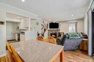 a kitchen and living room with a table and a couch at Hideaway Valley Condo 36 in Harbor Springs