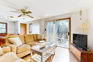 a living room with a couch and a tv at Eastham Glen in Eastham