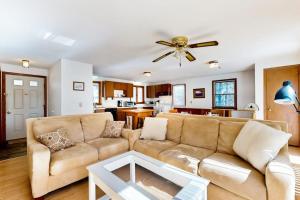 a living room with a couch and a ceiling fan at Eastham Glen in Eastham
