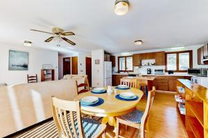 a dining room and kitchen with a table and chairs at Eastham Glen in Eastham +22 photos