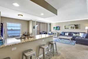 a living room with a bar and a living room with a couch at Marco Magic in Marco Island +28 photos