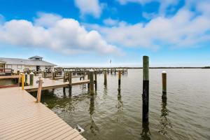 a dock on a body of water with a house at Marco Magic in Marco Island