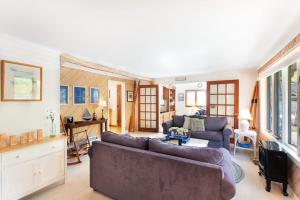 a living room with two couches and a table at Generations in Douglas