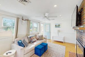 a living room with a couch and a fireplace at Coastal Hideaway in Eastham