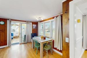 a dining room with a table and chairs at Coastal Hideaway in Eastham