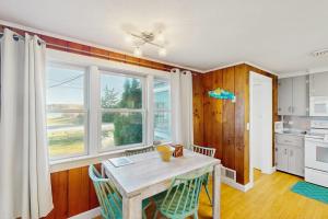 a kitchen with a table and chairs and a window at Coastal Hideaway in Eastham