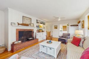a living room with a couch and a fireplace at Cozy Corner in Edgartown