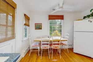 a kitchen with a table and a white refrigerator at Cozy Corner in Edgartown
