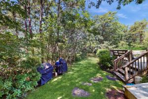 a yard with green grass and a wooden fence at The Big Easy in Oak Bluffs