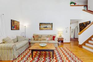 a living room with a couch and a coffee table at The Big Easy in Oak Bluffs