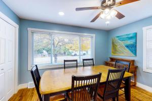a dining room with a table and chairs and a ceiling fan at Beach House in Empire