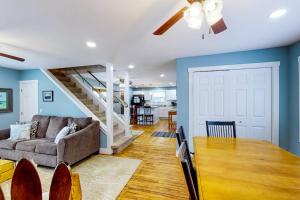 a living room with a couch and a dining room table at Beach House in Empire