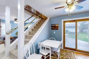 a dining room with a table and a staircase at Beach House in Empire +12 photos