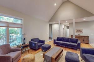a large living room with blue couches and a table at Deer Park 9 in Glen Arbor