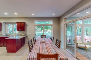 a kitchen and dining room with a table and chairs at Deer Park 9 in Glen Arbor