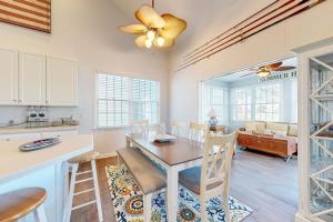 a kitchen and dining room with a table and chairs at Bear Trap Dunes---26 Willow Oak Ave in Ocean View