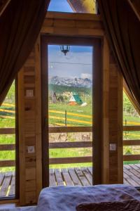 a view from a bedroom with a large window at Bugen Villa III in Žabljak