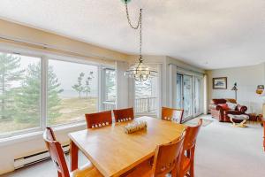 a dining room with a wooden table and chairs at South Beach 53 in Glen Arbor