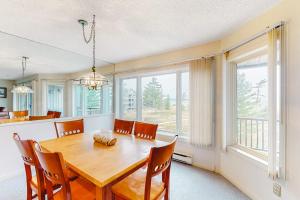 a dining room with a wooden table and chairs at South Beach 53 in Glen Arbor