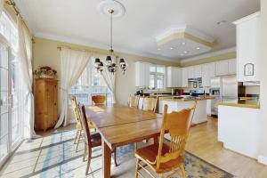 a kitchen and dining room with a wooden table and chairs at Beacon Court D in Douglas