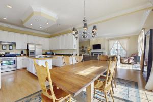 a large kitchen with a wooden table and chairs at Beacon Court D in Douglas