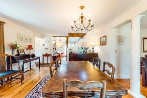 a dining room and living room with a table and chairs at Paradise On Cape Cod in Orleans