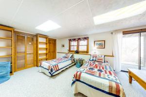 a bedroom with two beds and a window at Paradise On Cape Cod in Orleans