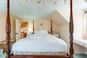 a bedroom with a canopy bed in a room at Paradise On Cape Cod in Orleans +39 photos