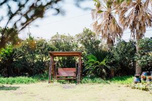 an old bench sitting in the middle of a yard at Moon Rabbit Pension in Jeju +10 photos