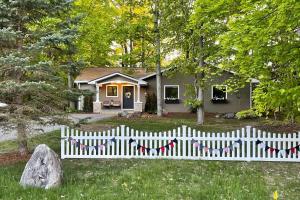 a white picket fence in front of a house at Torch Ridge Residence in Bellaire