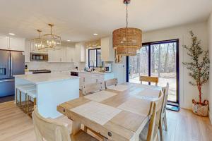 a kitchen with a wooden table and a dining room at Torch Ridge Residence in Bellaire