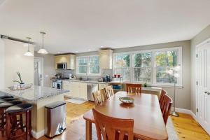 a kitchen and dining room with a table and chairs at Wraparound Hideaway in Provincetown