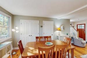 a dining room with a wooden table and chairs at Wraparound Hideaway in Provincetown