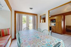 a dining room with a table and a couch at esCAPE in Eastham