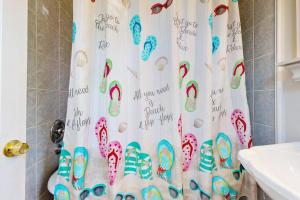 a shower curtain with footprints on it in a bathroom at esCAPE in Eastham +17 photos