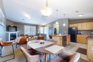 a kitchen and living room with a table and chairs at Northern Light Condominiums: Jack's Perch in Douglas