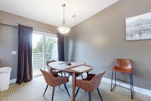 a dining room with a table and chairs and a window at Northern Light Condominiums: Jack's Perch in Douglas