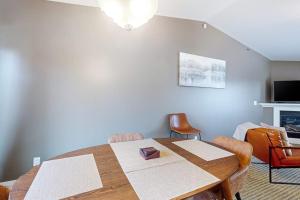 a dining room with a wooden table and chairs at Northern Light Condominiums: Jack's Perch in Douglas +35 photos