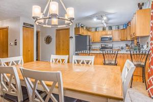 a kitchen and dining room with a wooden table and chairs at McKenzie's Lodge in Thompsonville