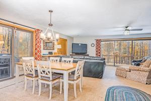 a dining room with a table and chairs and a couch at McKenzie's Lodge in Thompsonville