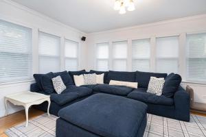 a blue couch in a living room with windows at Butterfly Pool House in Lakeside