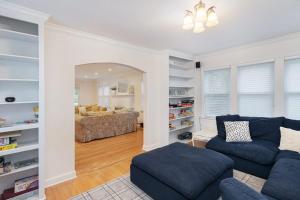a living room with a blue couch and a living room with a couch at Butterfly Pool House in Lakeside