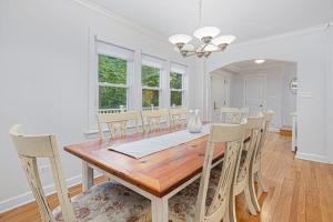 a dining room with a wooden table and chairs at Butterfly Pool House in Lakeside +23 photos
