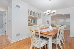 a kitchen and dining room with a table and chairs at Butterfly Pool House in Lakeside