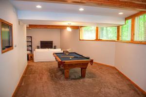 a living room with a pool table in it at Chalet Du Bois in Harbert +20 photos