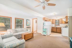 a living room with a couch and a ceiling fan at Goshorn Lake's Endless Summer in Saugatuck