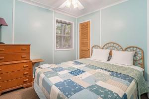 a bedroom with a bed and a dresser at Goshorn Lake's Endless Summer in Saugatuck +15 photos
